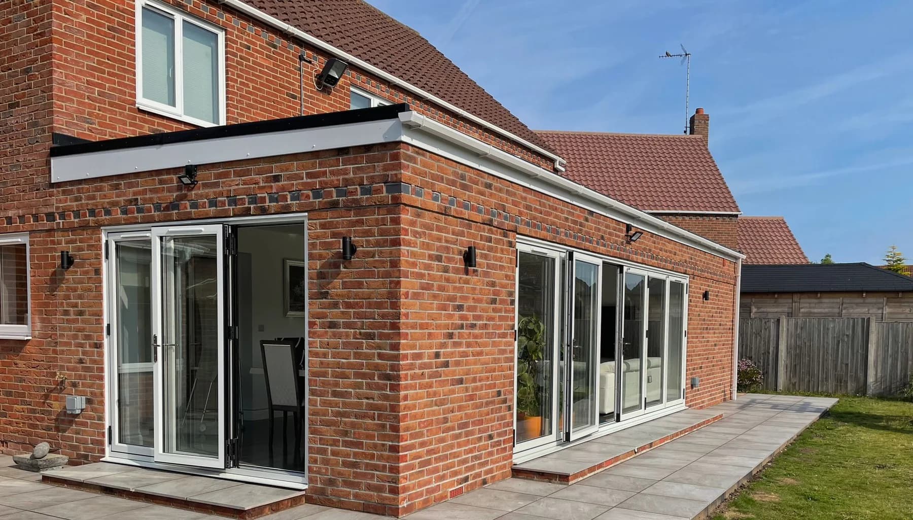 Corner view of the brick rear extension and paved patio