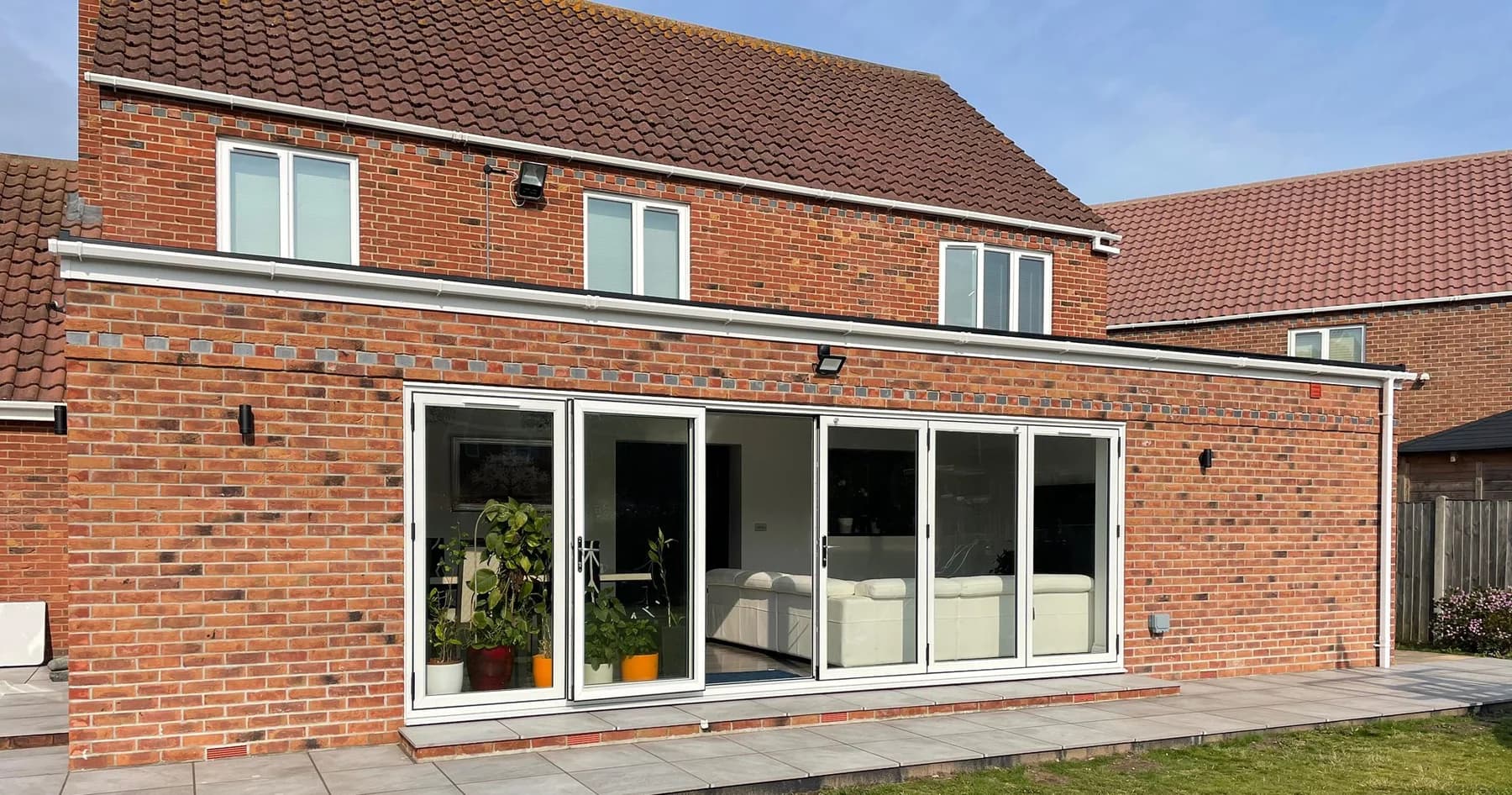 Wide view of the brick rear extension and garden doors