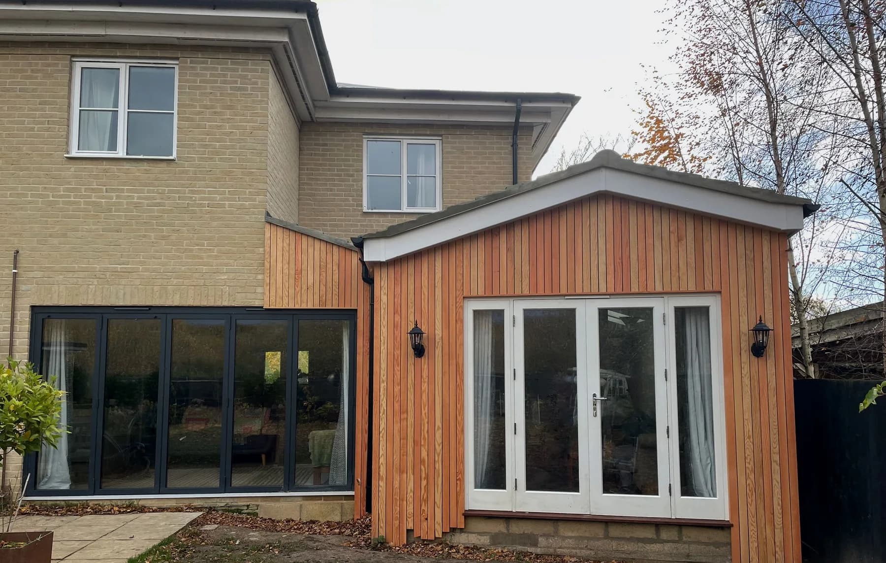 Full view of the timber clad rear extension and adjoining home